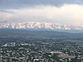 Panorama of Osh showing high, snow-capped peaks of the Alay Range to the south of city