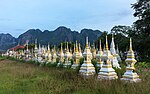 Thumbnail for File:White and golden graves in a Buddhist cemetery at sunrise in Vang Vieng, Laos.jpg