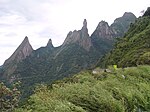 Forested mountains topped by rocks