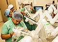 Image 38Medical personnel place sterilized covers on the arms of the daVinci Xi surgical system, a minimally-invasive robotic surgery system, at the William Beaumont Army Medical Center. (from History of medicine)