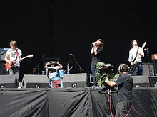 Idlewild performing onstage playing and singing into a microphone