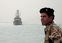 US Navy 080813-N-5068C-008 An Iraqi sailor looks on from the pier as the coastal patrol boat USS Firebolt (PC 10) arrives at the port of Umm Qasr.jpg