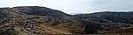 Landscape of brown hills with many scattered rocks.