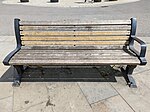 Wooden bench with backrest and one armrest.jpg