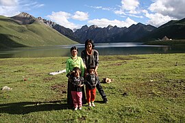 Local nomadic Tibetan herdsmen family standing in front of Lake Ximencuo on the Tibetan Plateau.jpg