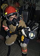 US Navy 031010-N-9214D-230 USS Shiloh (CG 67) damage control fire fighters practice firefighting skills during a main-space fire drill.jpg