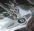 A Bentley badge and hood ornament