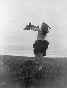 Mandan hunter with buffalo skull, c. 1909