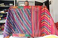 Seller showing Jamdani saree.