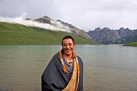 Local Tibetan standing in front of Lake Ximencuo on the Tibetan Plateau.jpg