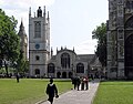 St Margaret's Church. To the left is the Elizabeth Tower of the Palace of Westminster; to the right is the Abbey.