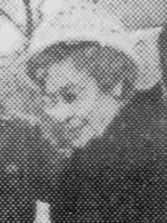 A 1982 newspaper photograph of an older white woman, wearing a hat and glasses.