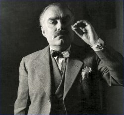 middle aged man, smartly dressed, with thinning hair and large moustache