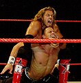 Edge applying the Camel Clutch on John Cena