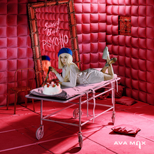 Max is positioned on top of a stretcher with a cake while holding a knife. The song title is written on the mirror behind her inside of a red room.