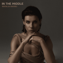 The cover artwork for "In the Middle". The cover features Natalia Barbu with her hands underneath her chin amongst a grey background.