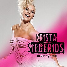 The cover artwork for "Marry Me". The cover features Krista Siegfrids in a wedding dress amongst a grey and pink background.