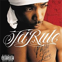 An image of a shirtless man wearing a white doo rag with the album title tattooed on his left chest breast, standing behind a red brick wall.