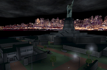 Statue of Liberty, depicted at nighttime, surrounded by a darkened island with grey structures, with skyline in the distance