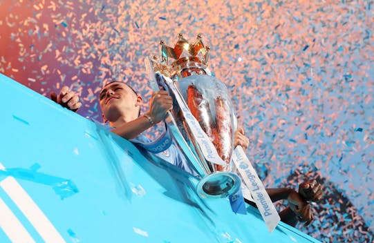 MANCHESTER, ENGLAND - MAY 26: Phil Foden of Manchester City celebrates with the Premier League Trophy during the Manchester City trophy parade on May 26, 2024 in Manchester, England. (Photo by Jess Hornby/Getty Images)