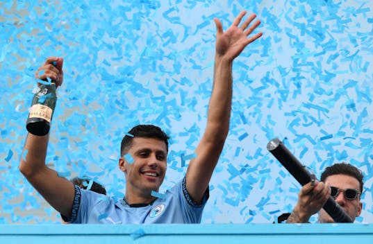 MANCHESTER, ENGLAND - MAY 26: Rodri of Manchester City celebrates as Ederson uses a confetti cannon during the Manchester City trophy parade on May 26, 2024 in Manchester, England. (Photo by Ben Roberts Photo/Getty Images)