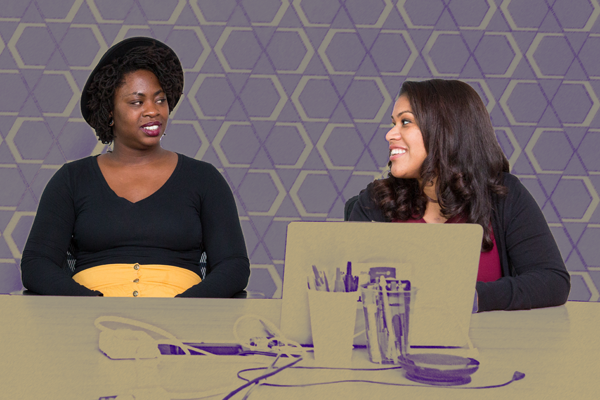 Two smiling people sitting at a table