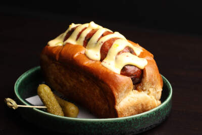 A hot dog at Merai, a Thai-inspired bar and restaurant in Brookline Village. (Jonathan Wiggs/The Boston Globe via Getty Images)