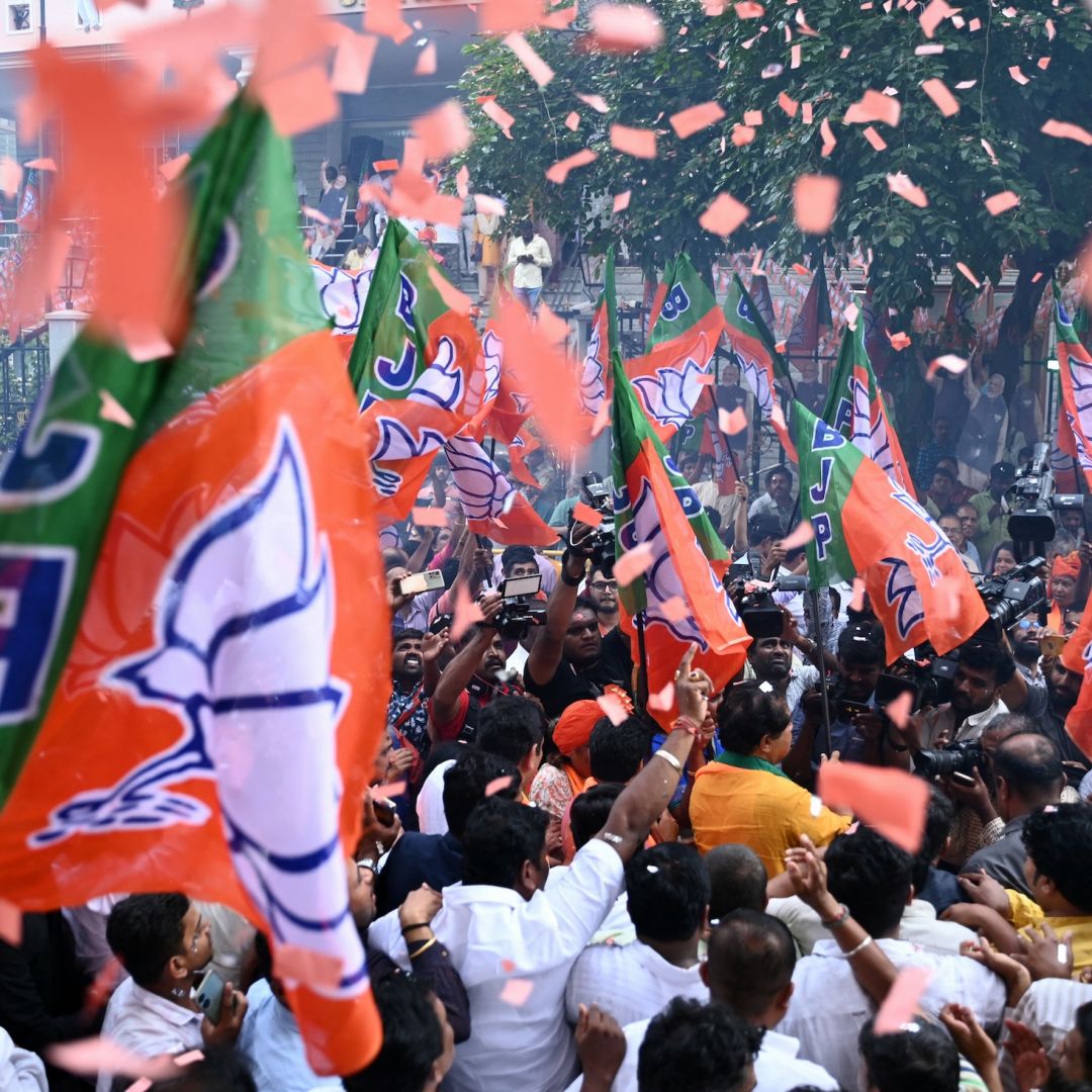 Supporters of Prime Minister Narendra Modi's Bharatiya Janata Party (BJP) celebrate vote counting results for India's general election in Bengaluru on June 4, 2024. 