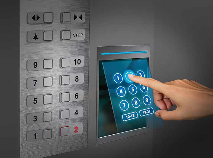 a finger hovers over a holographic projection of a keypad, selecting an elevator floor