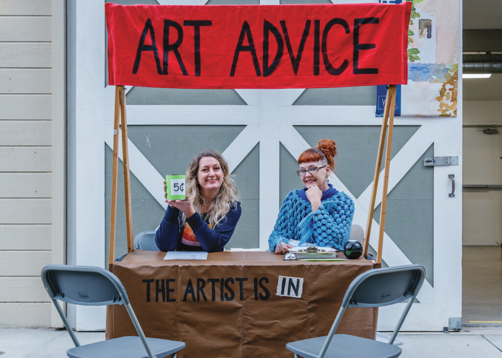 Gioia Fonda and Ianna Frisby sitting at their Art Advice Booth