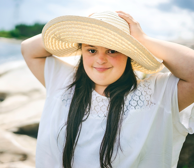 beautiful woman in beach hat at beach shore