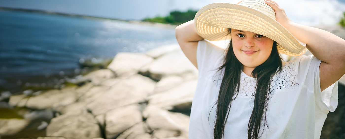 beautiful woman in beach hat at beach shore