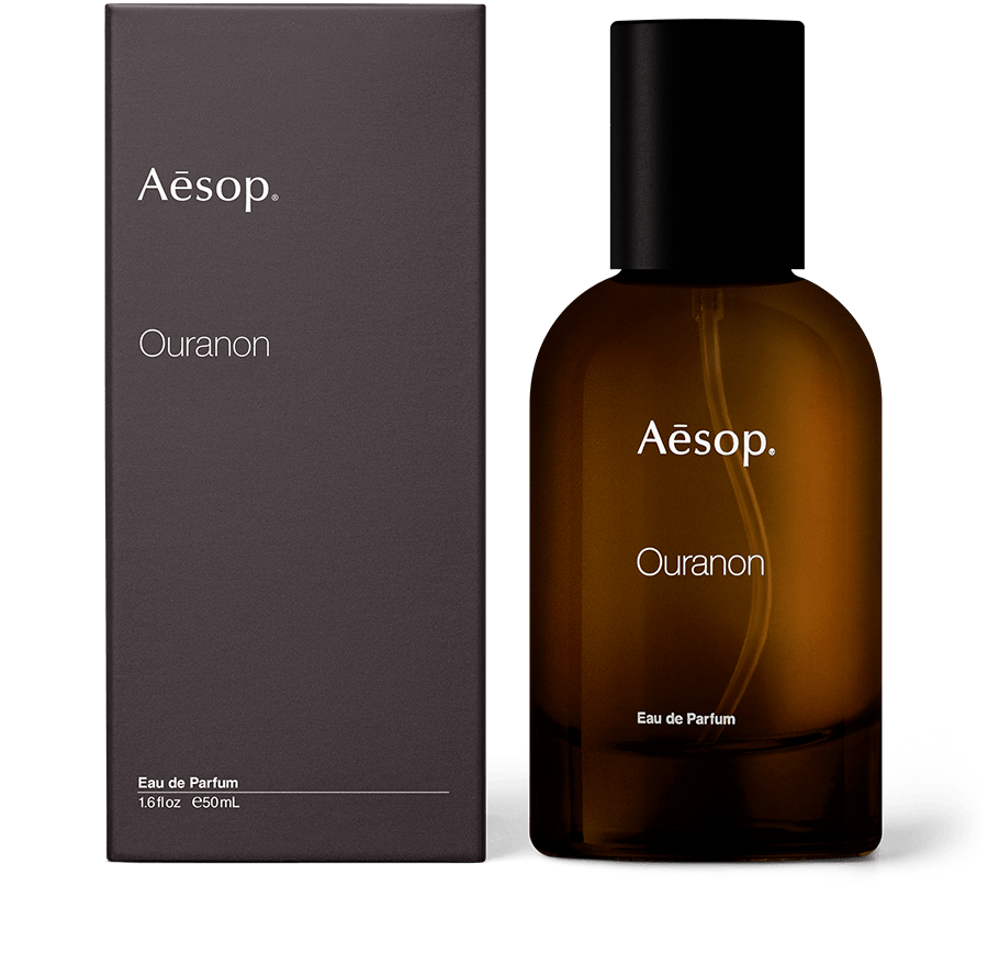 An amber bottle of Ouranon Eau de Parfum alongside carton packaging. 