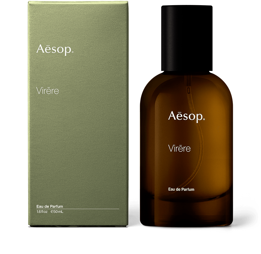 An amber glass bottle of Virēre Eau de Parfum alongside green carton packaging. 