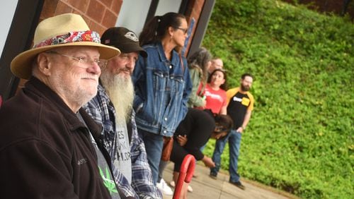 In this file photo, Ken Moore, of Woodstock, (left) and Les Wilson, of Powder Springs, (center) wait for Trulieve Medical Marijuana Dispensary to open up in Marietta on Friday April 28, 2023. Georgia's first medical marijuana dispensaries opened today in Marietta and in Macon. (Photo by Rebecca Breyer/freelance photographer)