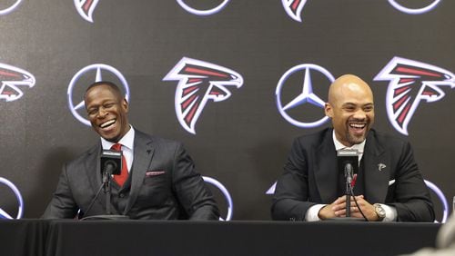 Raheem Morris and general manager Terry Fontenot share a laugh while responding to a question during Monday's introductory press conference for Morris.