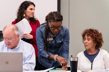 Cobb County Board of Elections chair Tori Silas, center, and assistant secretary Debbie Fisher, right, talk before a board meeting at the Cobb County Safety Village in Marietta, GA on Saturday, August 3, 2024.