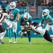 Kevin King (32) of the Atlanta Falcons tackles Malik Washington (83) of the Miami Dolphins during the second quarter in a preseason game at Hard Rock Stadium on Friday, Aug. 9, 2024, in Miami Gardens, Florida. (Rich Storry/Getty Images/TNS)