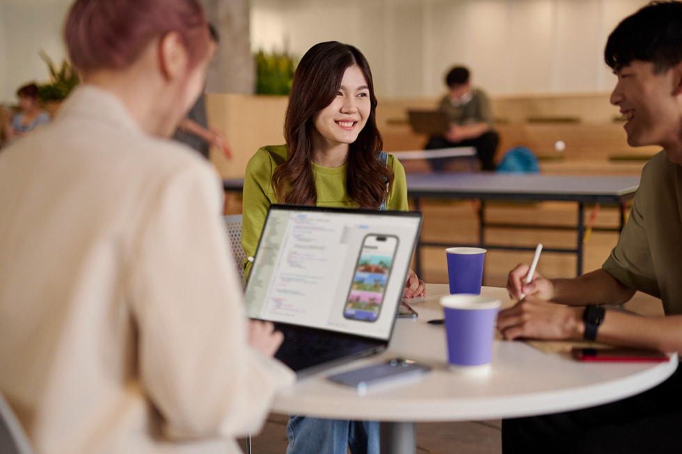 Three developers sitting around a table is shown.