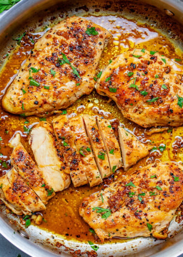 Garlic Butter Chicken - Tender, juicy chicken bathed in a rich garlic butter sauce with a splash of wine for extra flavor!! This EASY stovetop chicken recipe is ready in 15 minutes and will become a family FAVORITE!!