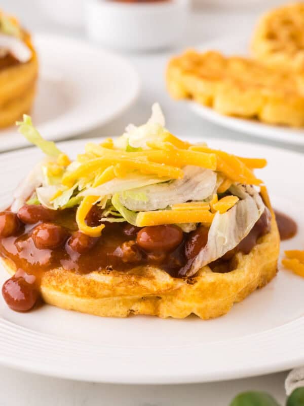 round white plate with cornbread waffles and chili.