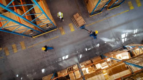 Top-down view of workers moving boxes in a warehouse