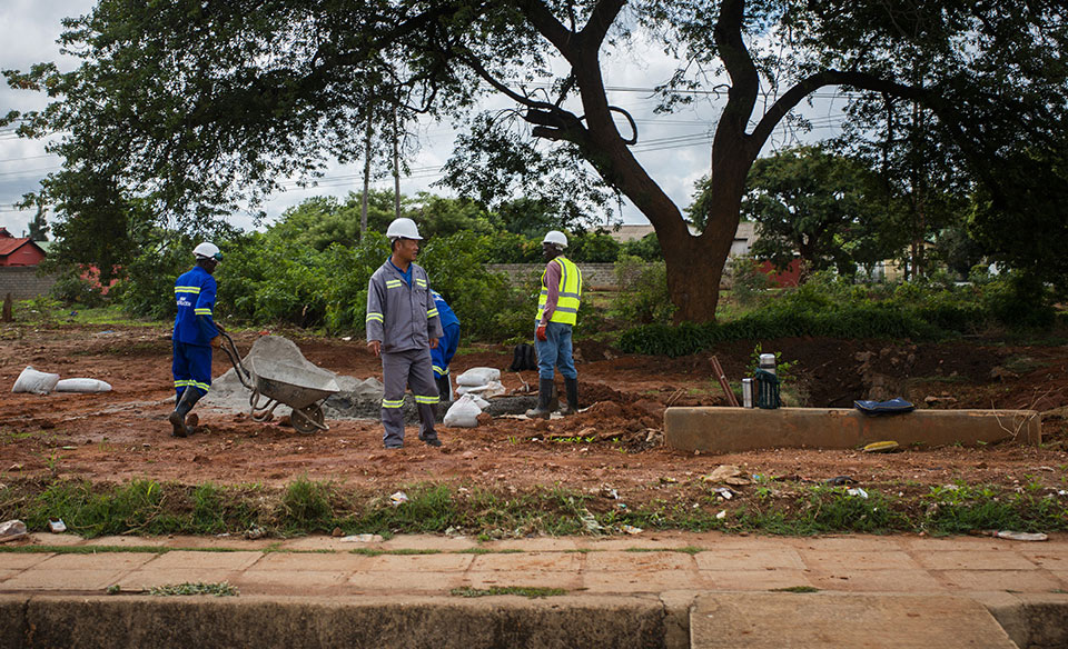 Chinese construction worker pauses in Lusaka, Zambia, in 2018. China is building and financing most of the digital infrastructure projects in Zambia.