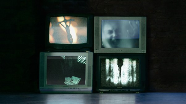 Three tv screens showing shadowy horror film images and a fourth screen showing a cross.