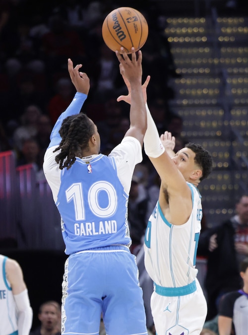 Cavaliers guard Darius Garland (10) hits a three-point shot