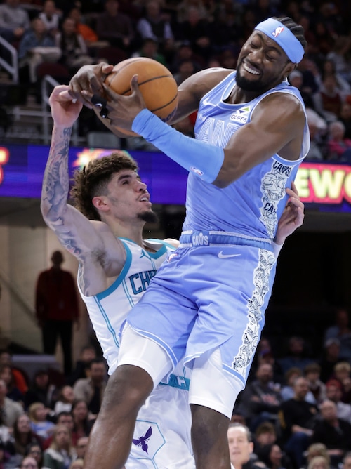 Cavaliers guard Caris LeVert (3) is fouled by Hornets guard LaMelo Ball