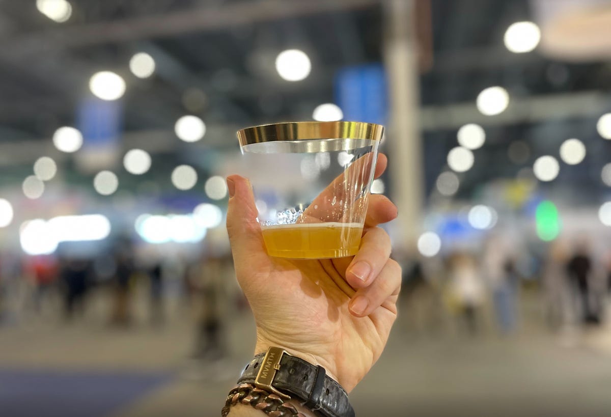 hand holding sample of beer