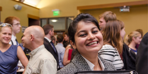 young CU alumn at a career networking event