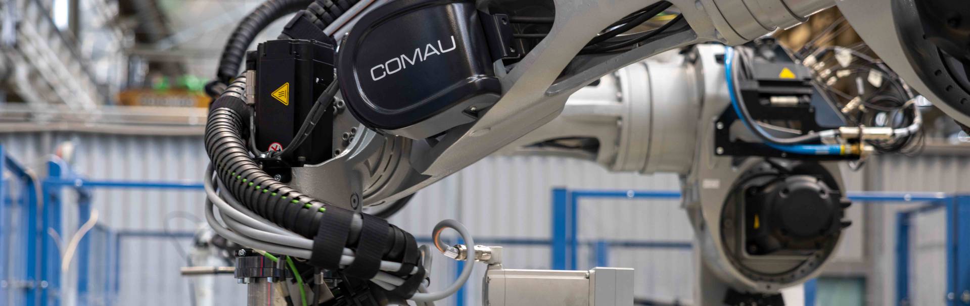 comau robot in industrial environment