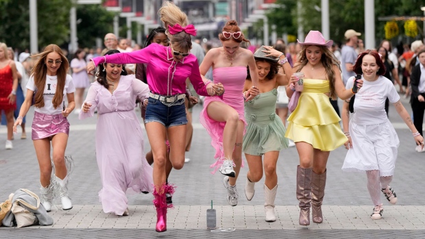 Fans of singer Taylor Swift, called 'Swifties', arrive at Wembley Stadium in London, Thursday, Aug. 15, 2024 for the first of five concerts of Taylor Swift's Eras Tour.(AP Photo/Alastair Grant)